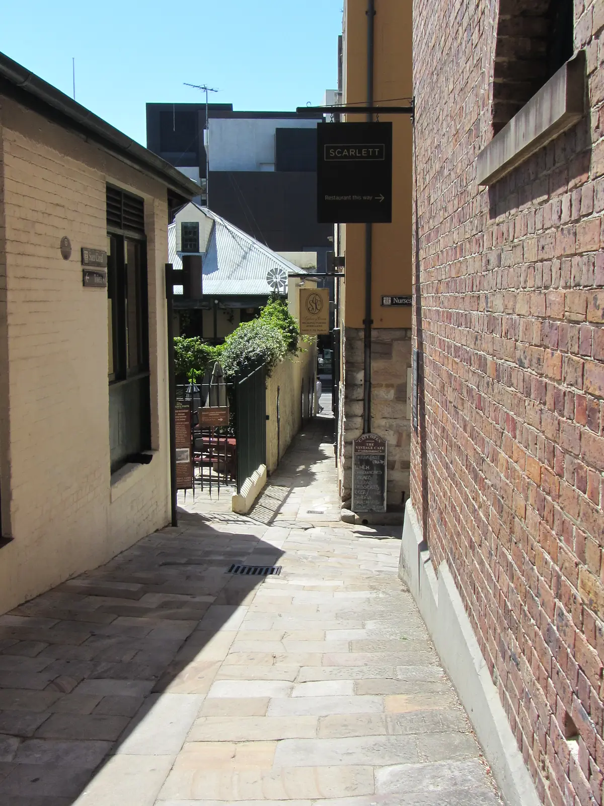A narrow lane in The Rocks with brick walls and sandstone paving